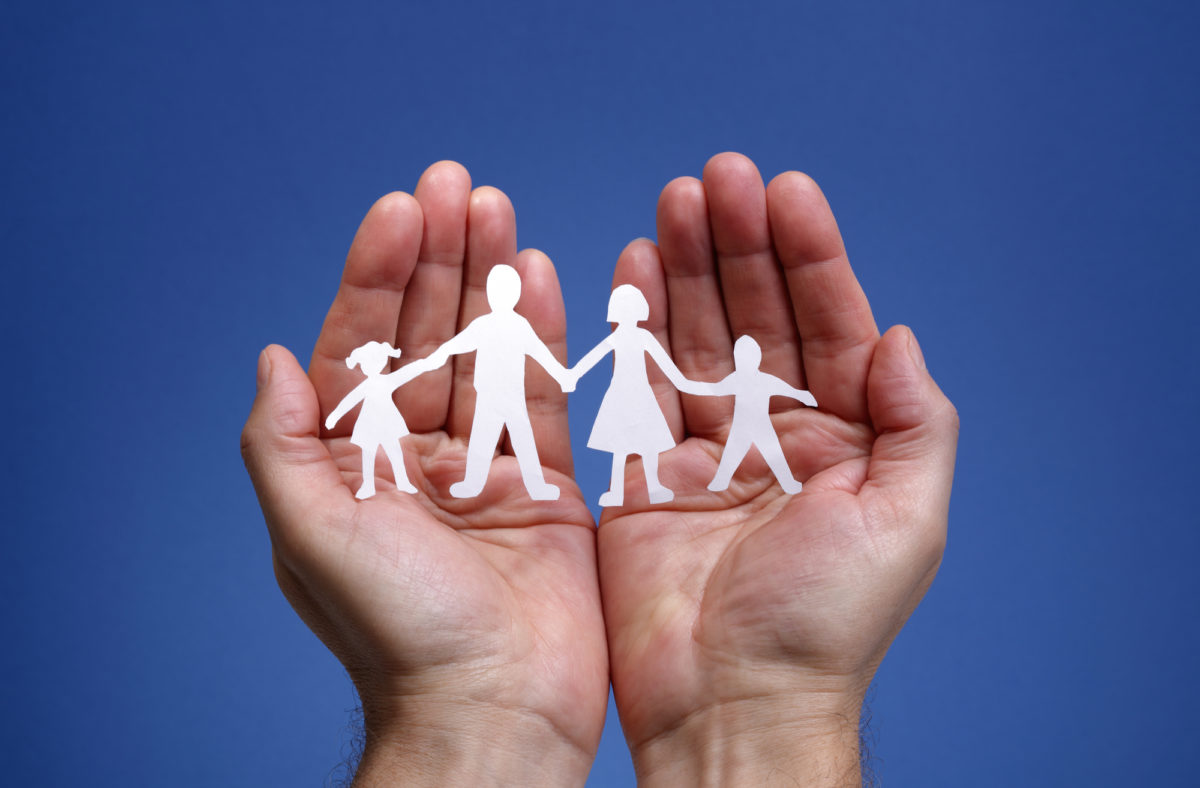 Paper chain family protected in cupped hands